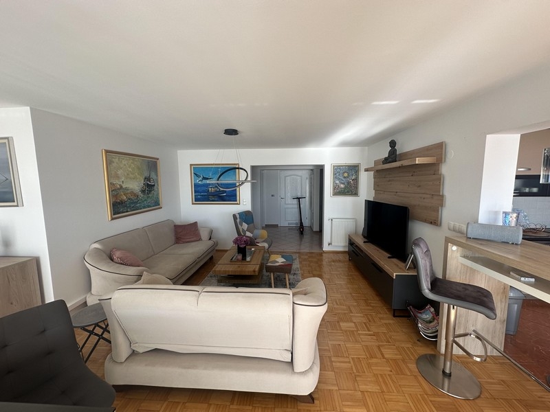 Living room with sofa area and open transition to the kitchen