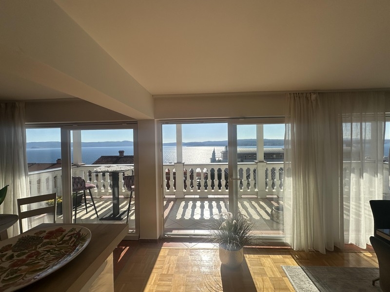 Living area with large window front and access to the balcony with sea views