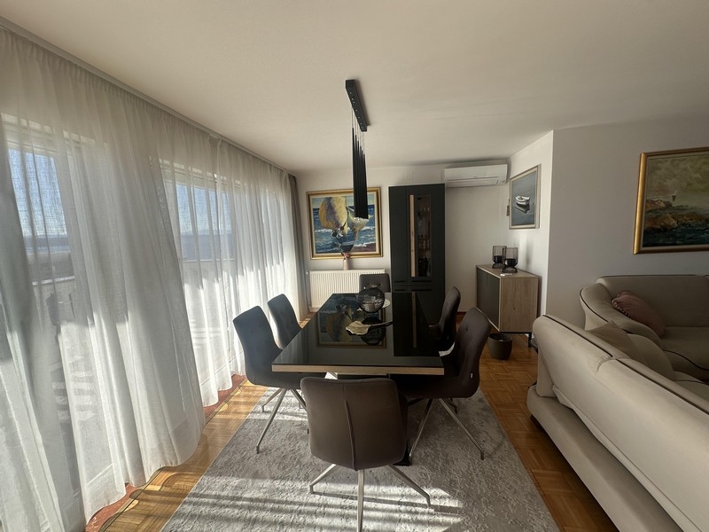 Dining area with table and floor-to-ceiling windows