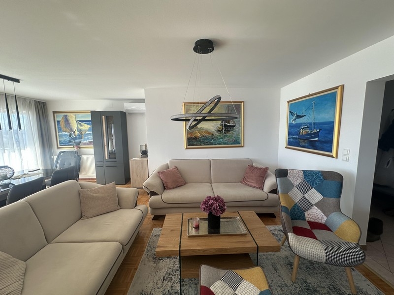 Bright living room with sofa, coffee table and wall pictures