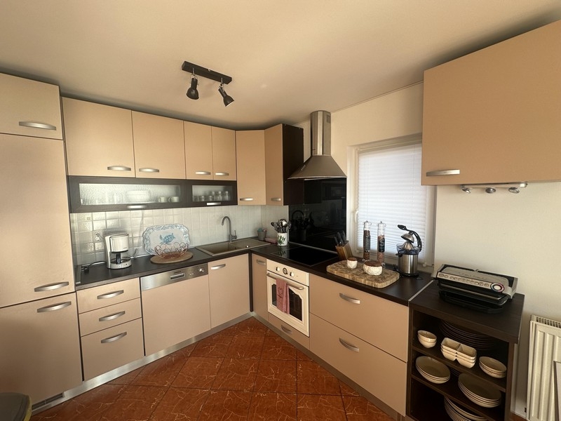 Separate kitchen with built-in appliances and work surfaces