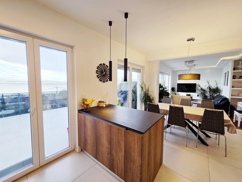Kitchen counter with terrace door and view into the living room