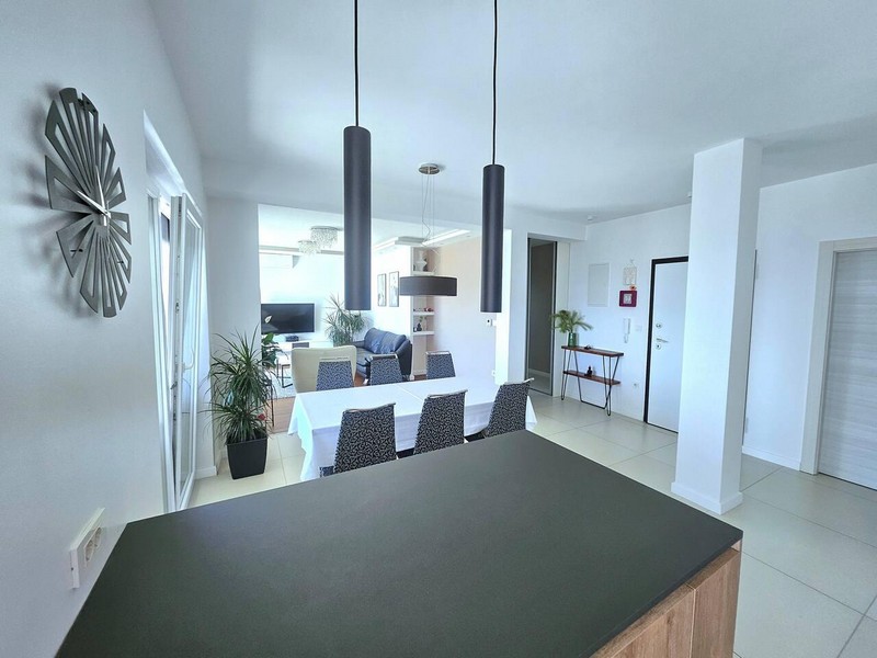 Kitchen counter with view of the dining area and entrance hallway