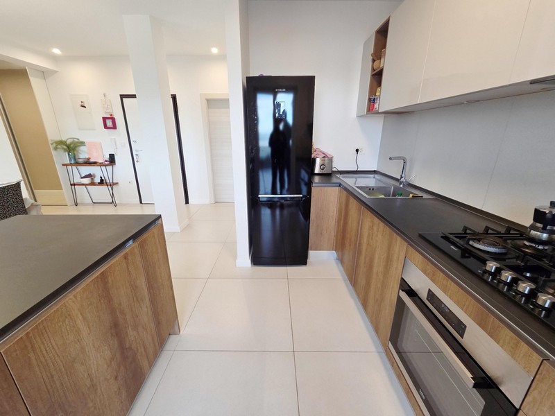 Kitchen with black refrigerator and sink