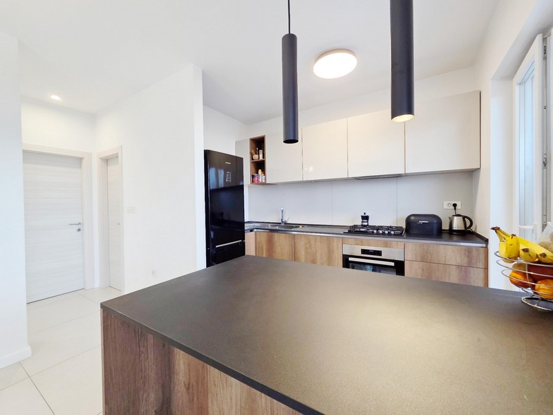 Kitchen with kitchen island and black pendant lights