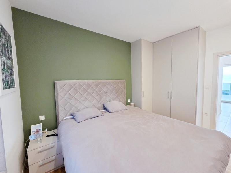 Double bed with upholstered headboard and wardrobe