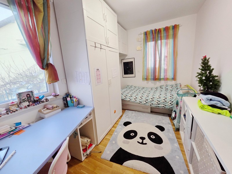 Children's bedroom with panda rug, desk and cupboard