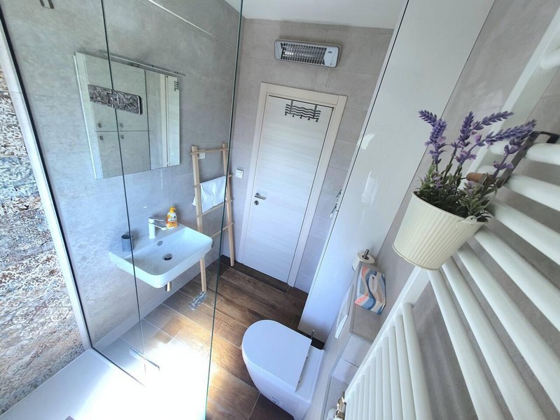 Bathroom with glass shower and heated towel rail