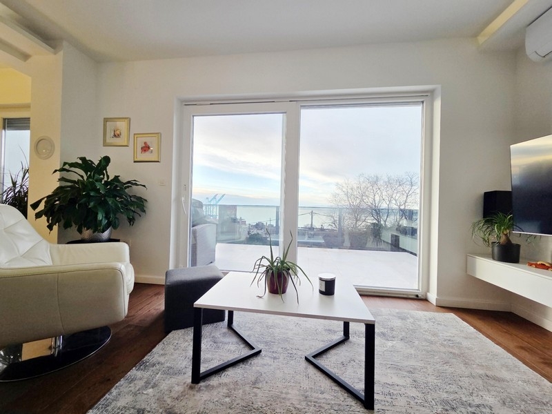 Bright living area with sliding doors and city and sea views