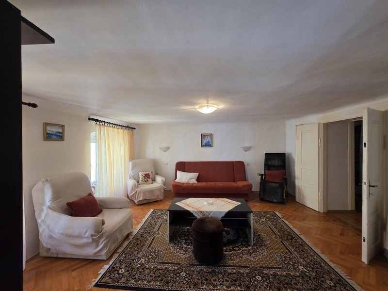 Large living room with parquet floors in apartment