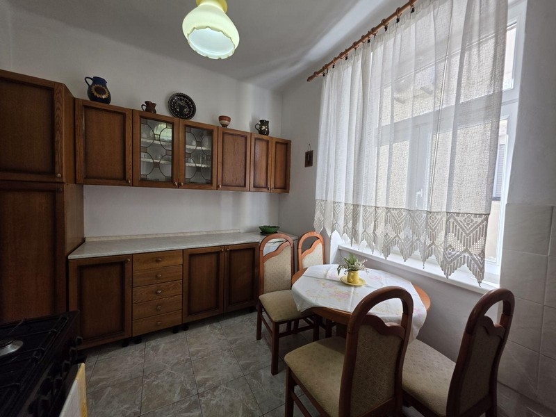 Kitchen with wooden cabinets and small seating area