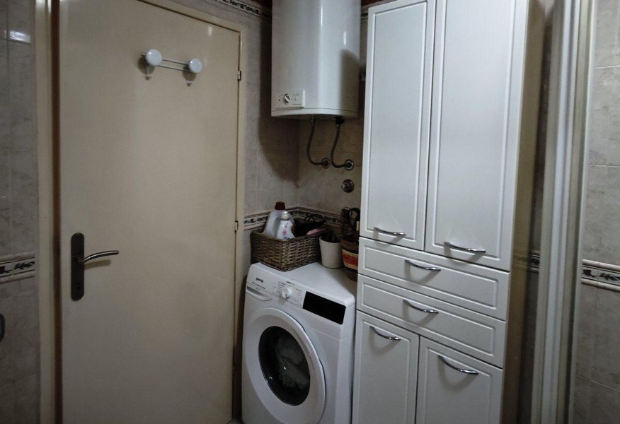 Utility room with washing machine and storage space