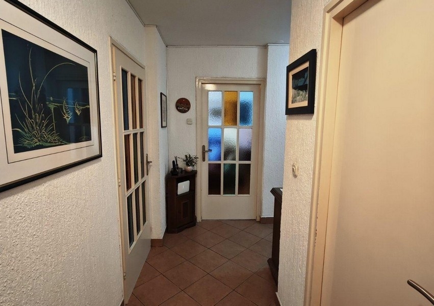Hallway with decorative glass doors and murals