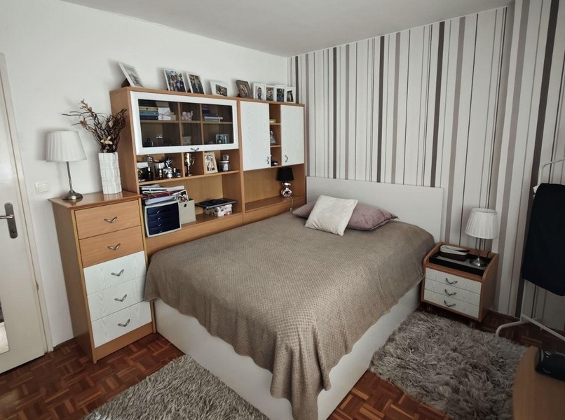 Bedroom with double bed and built-in furniture