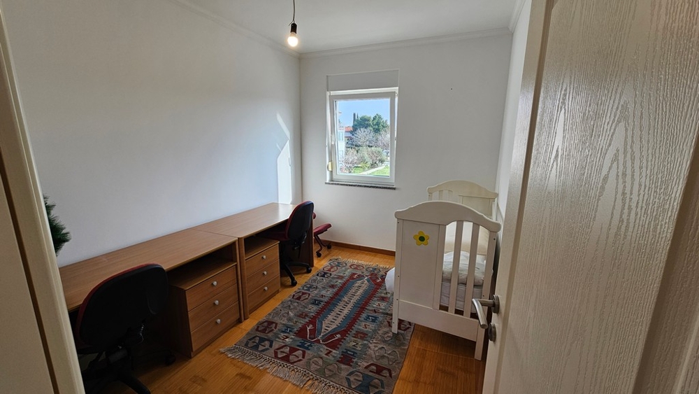 Small bedroom with desk in apartment