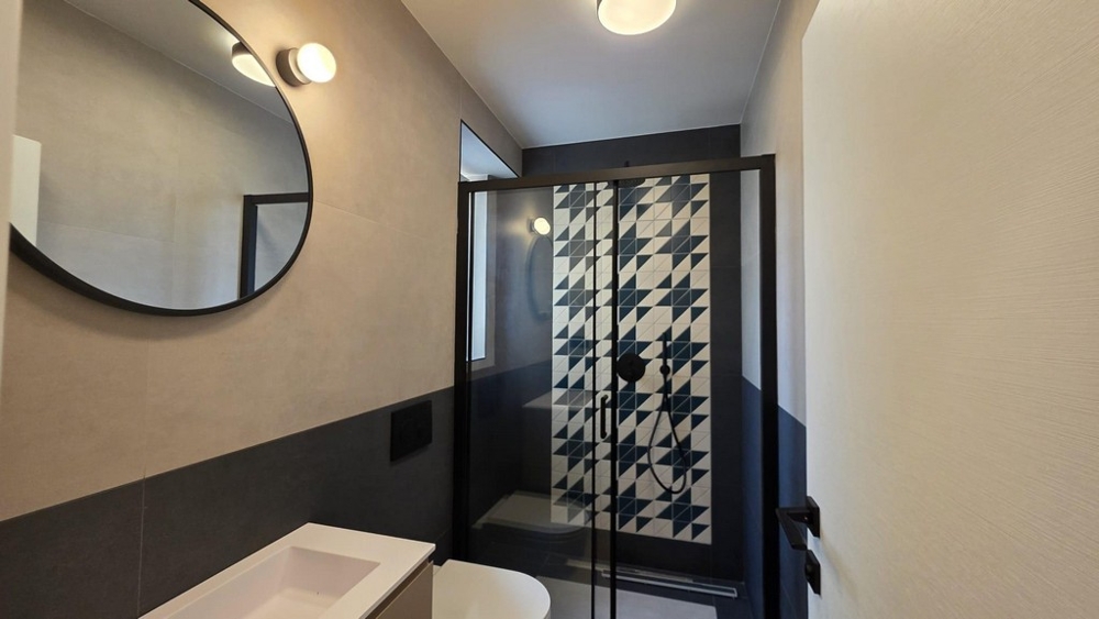 Kitchen area with built-in appliances and access to the balcony
