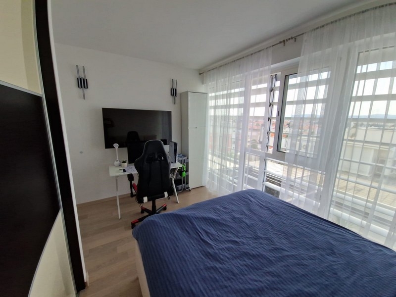 Bedroom with workplace and balcony access