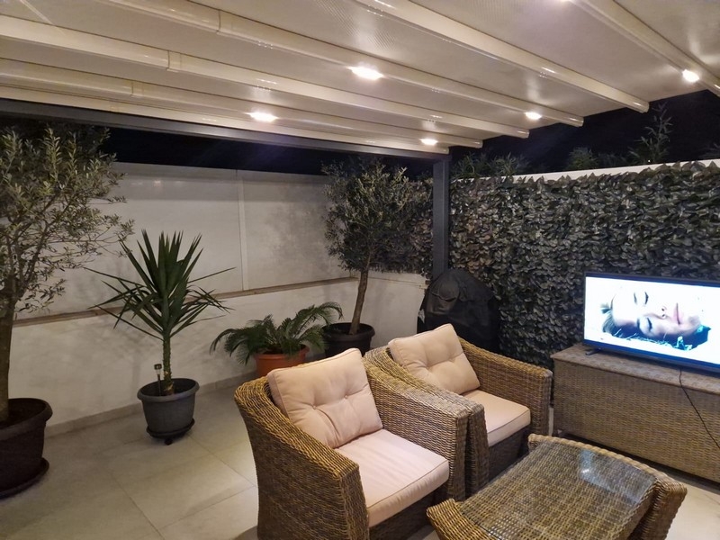 Covered terrace with lounge and lighting