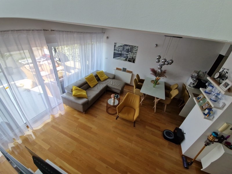 Bright living area with gallery and large windows