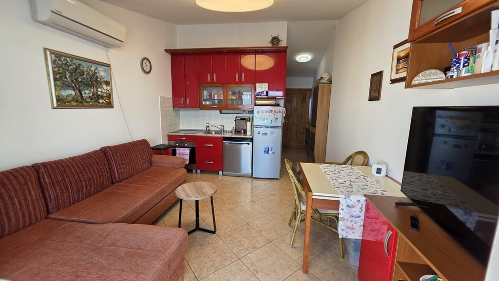 Living area with sofa and open kitchen