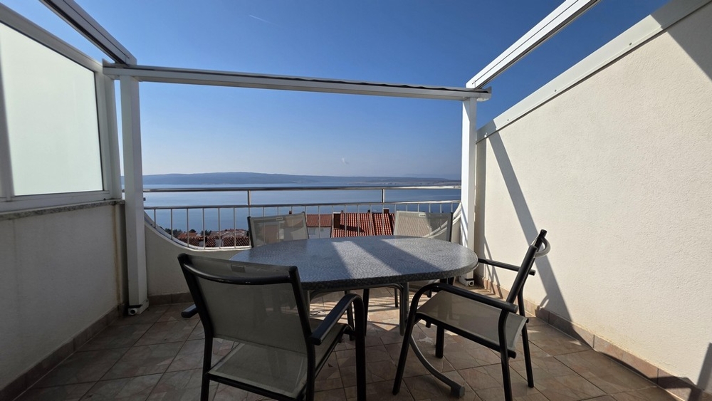 Balcony with seating area and panoramic sea views