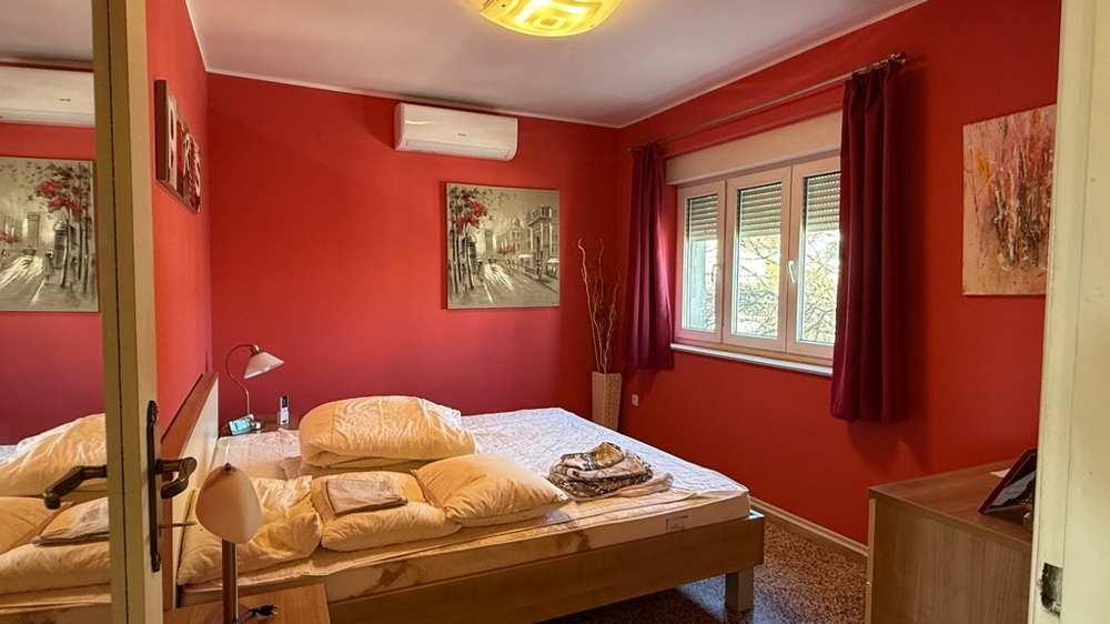 Bedroom with window and red wall design