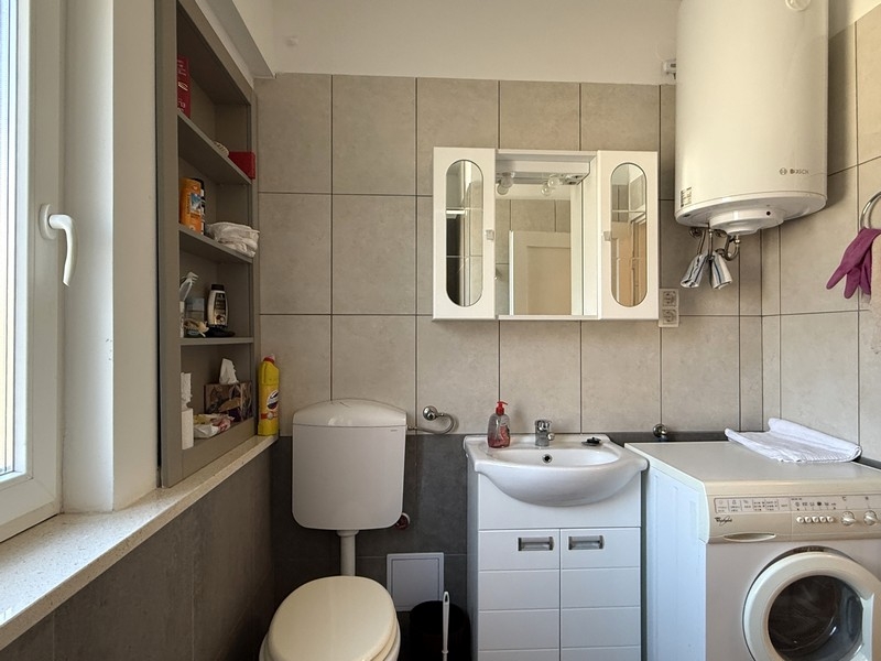 Bathroom with washing machine and sink