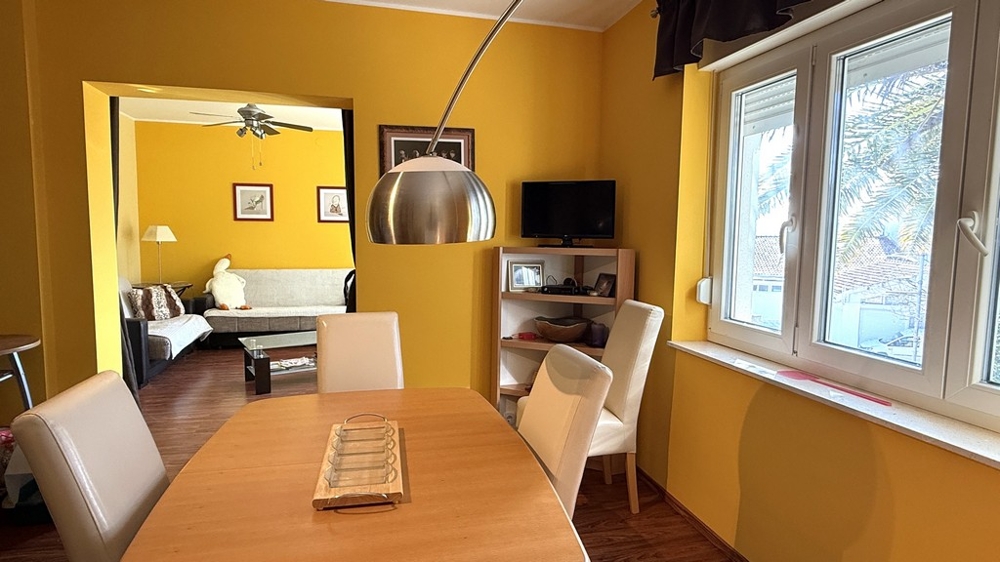 Dining area with table and passage to the living room