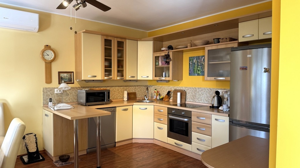Living area with access to the kitchen and hallway