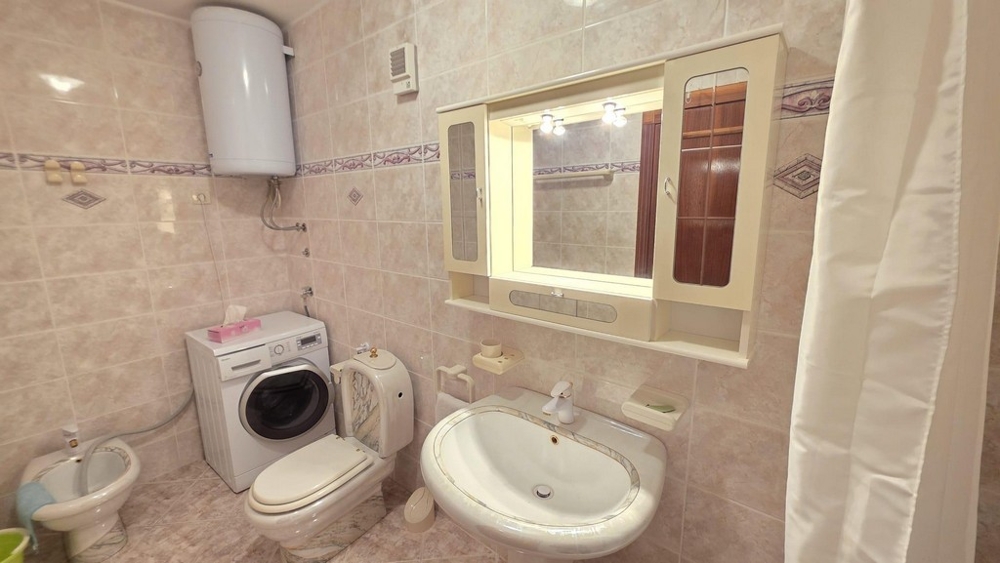 Bathroom with washing machine and mirror