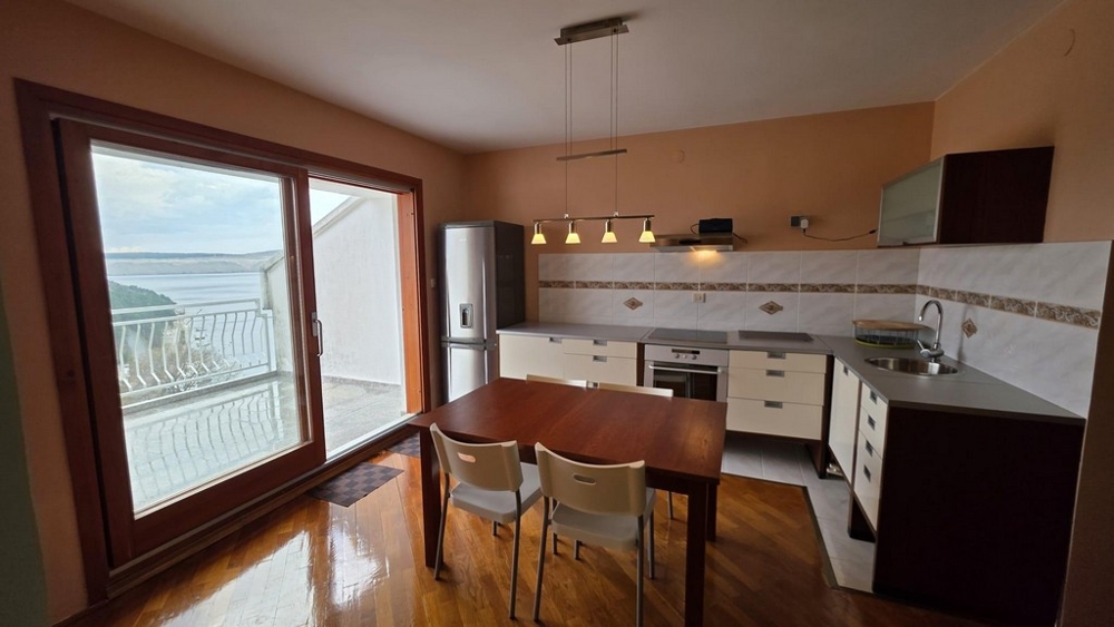 Open kitchen with built-in appliances and dining area