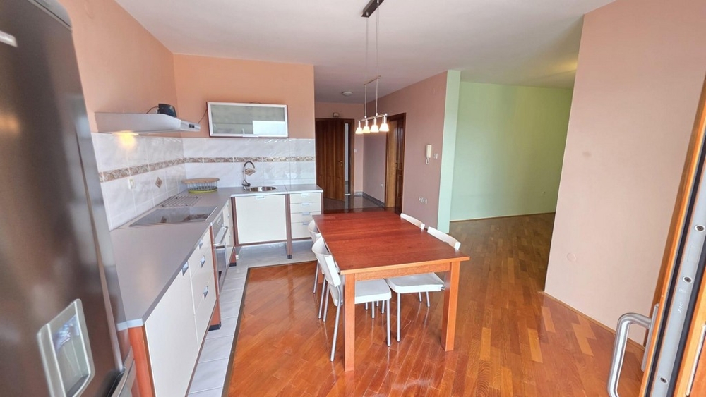 Living area with kitchen and view into the hallway