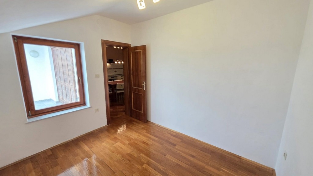 Bedroom with wooden floor and window