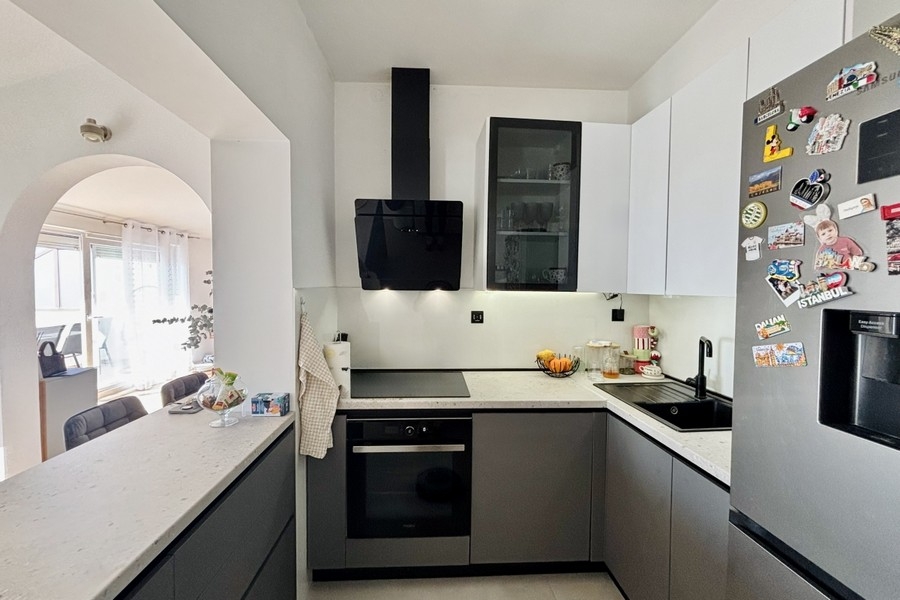 Modern fitted kitchen with cooking island and high-quality appliances