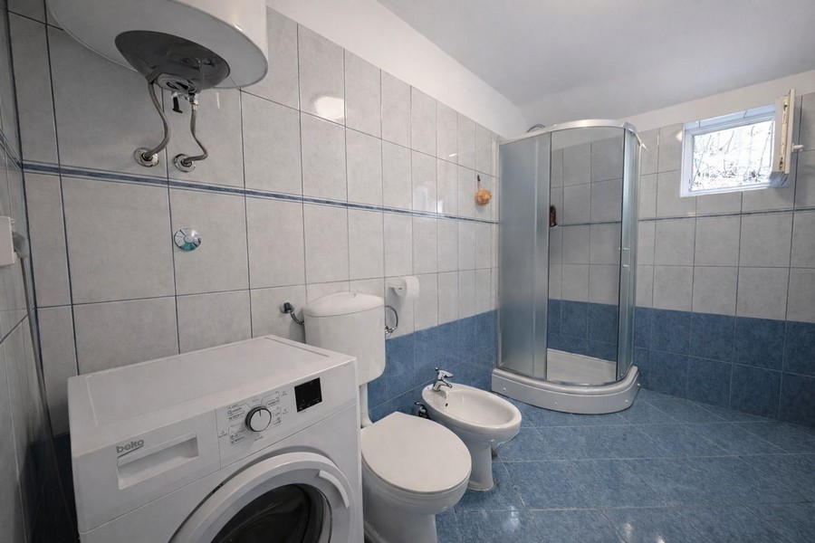 Bathroom with shower and washing machine