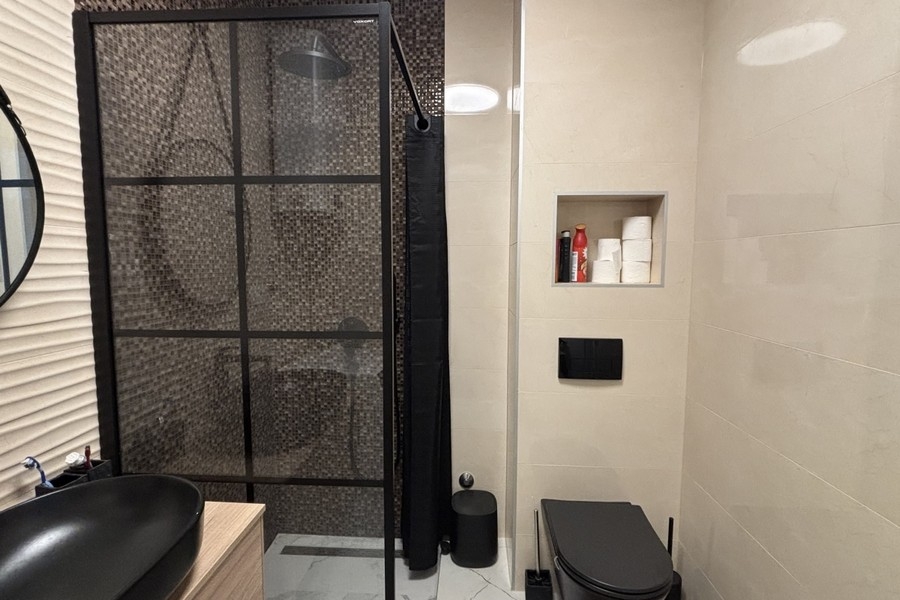 Bathroom with shower and black fittings