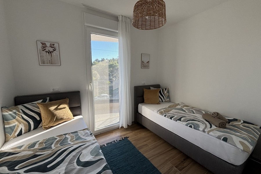 Bedroom with two single beds and balcony access