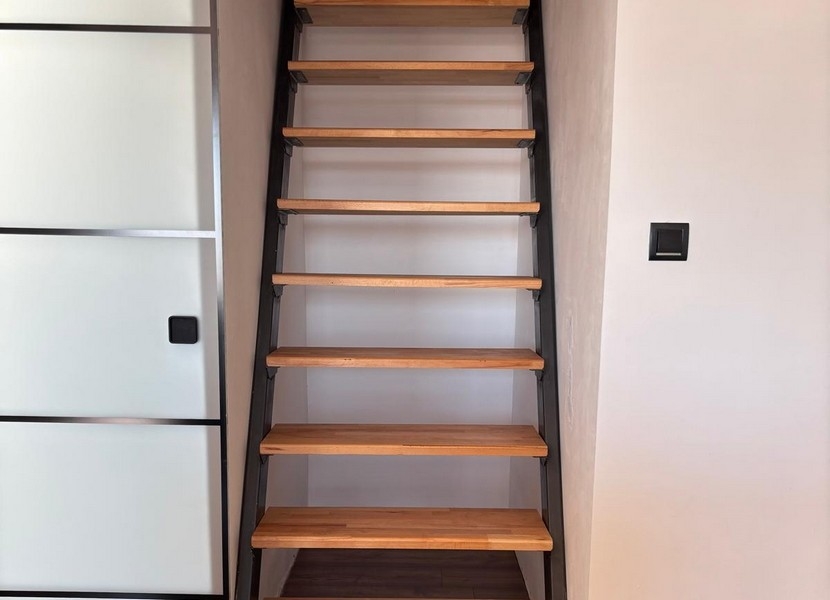 Children's room in the attic with a sloping ceiling and work area