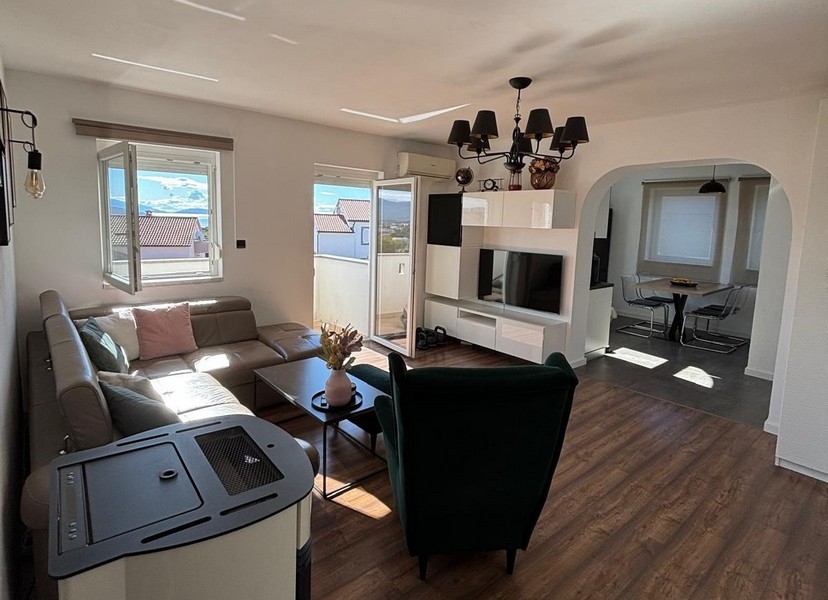 Bright living room with modern furnishings and large windows