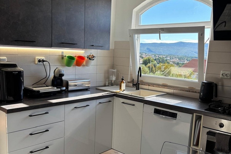 Sea views from the kitchen over rooftops and coastal landscape