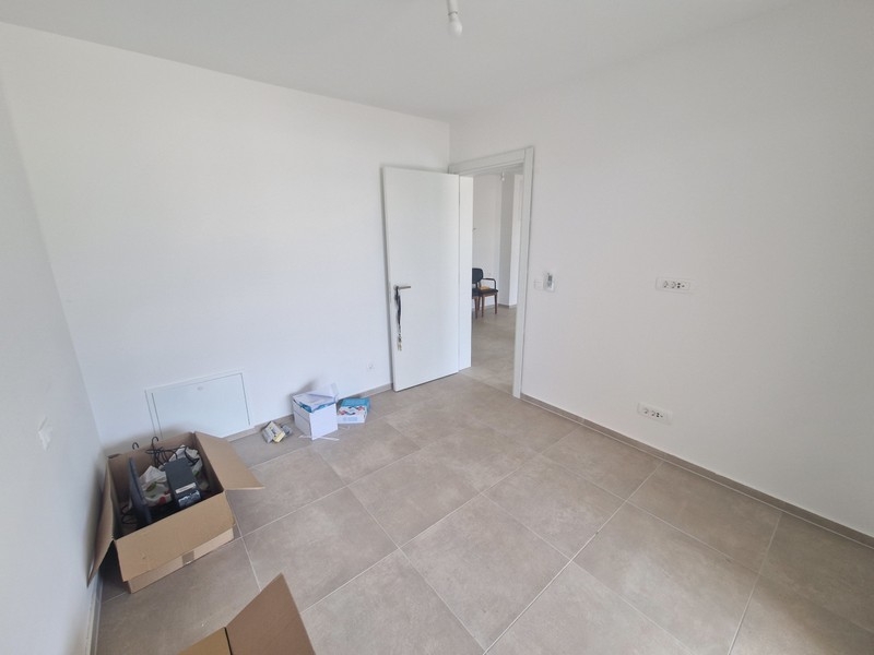 Room with tiled floors and neutral furnishings