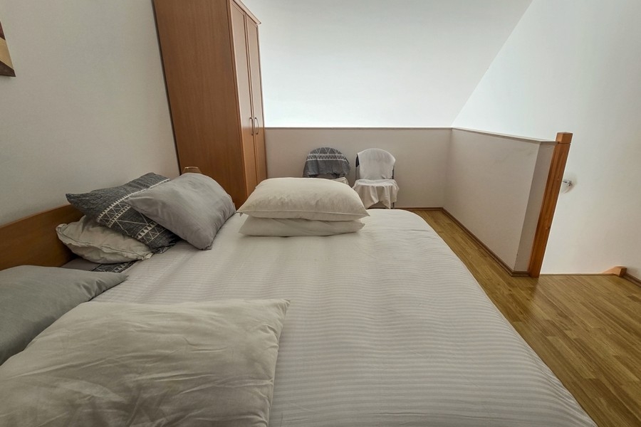 Sleeping area on the gallery with double bed and wardrobe