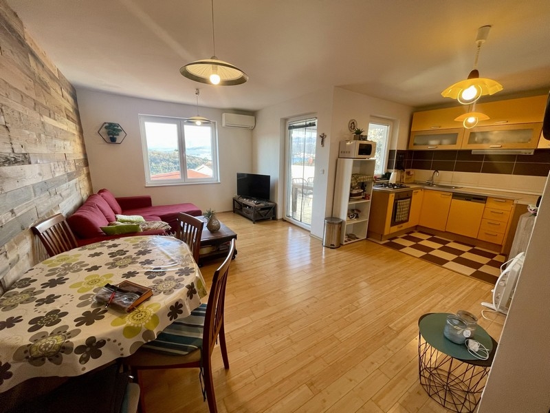 Living area with open kitchen and access to the balcony with sea views