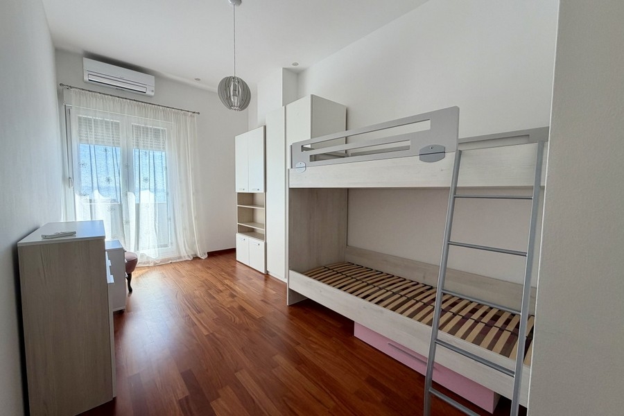 Bright children's room with bunk beds and air conditioning