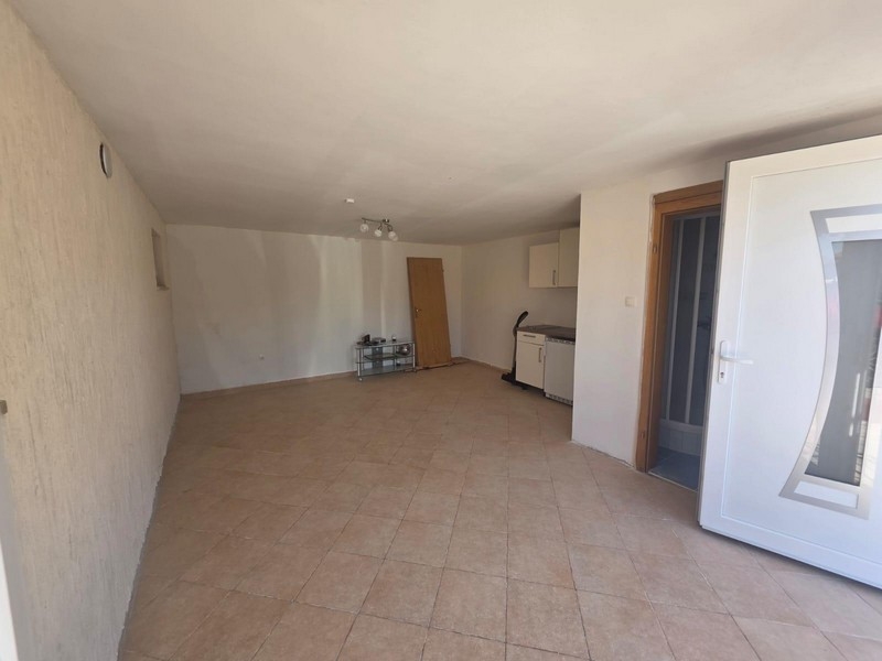 Outdoor area with paved terrace and parking spaces