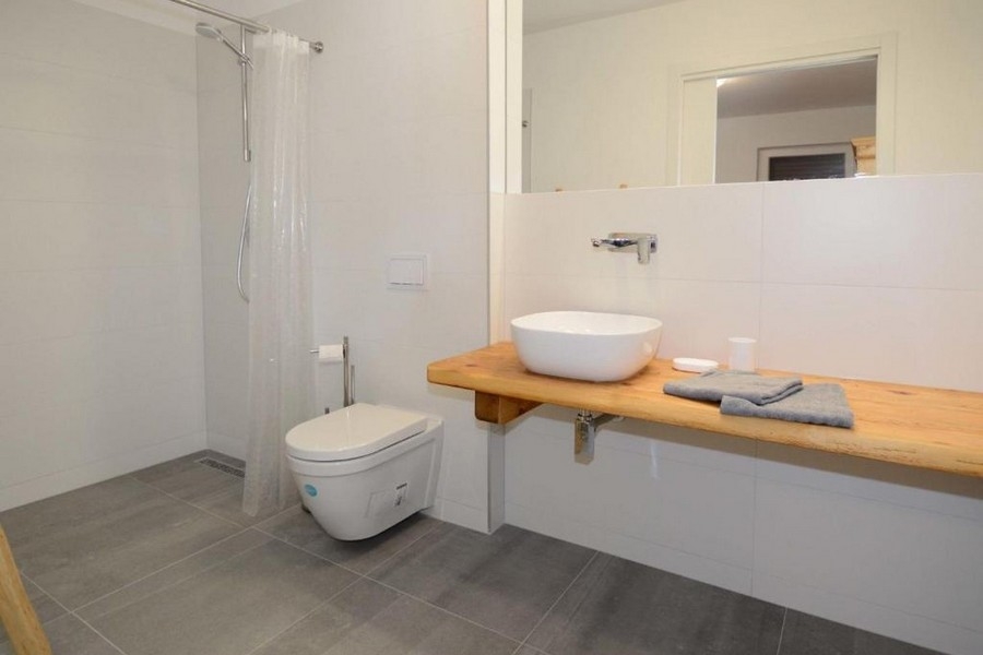 Modern bathroom with shower, sink and toilet