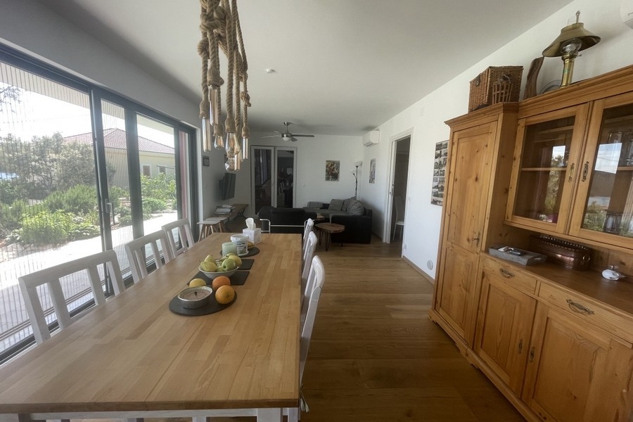 Open living and dining area with large windows and a view of the countryside