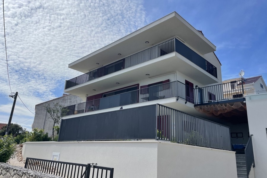Bright living and dining area with large windows and sea views