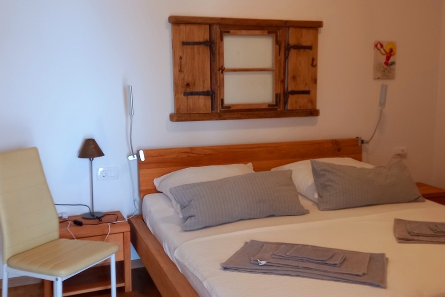 Bedroom with double bed and simple furnishings