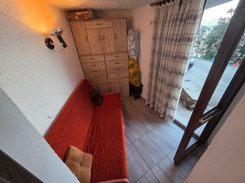 Small living area with sofa and access to the outside